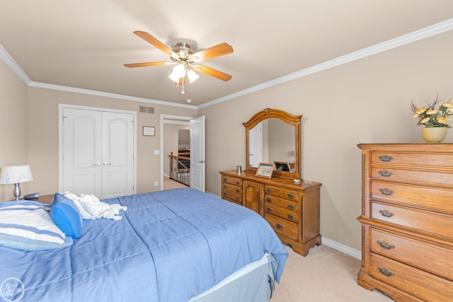 bedroom featuring visible vents, light colored carpet, ornamental molding, a closet, and a ceiling fan