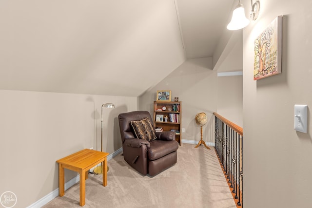 living area with light colored carpet, baseboards, and lofted ceiling