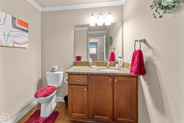 bathroom with wood finished floors, toilet, ornamental molding, and vanity