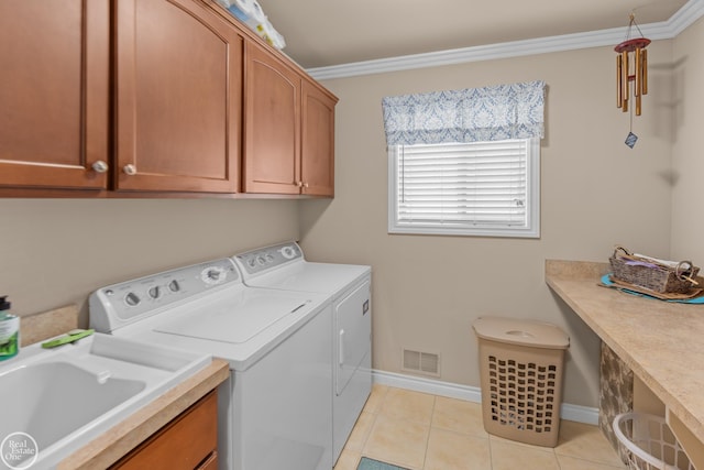 laundry room with washer and dryer, crown molding, cabinet space, and visible vents