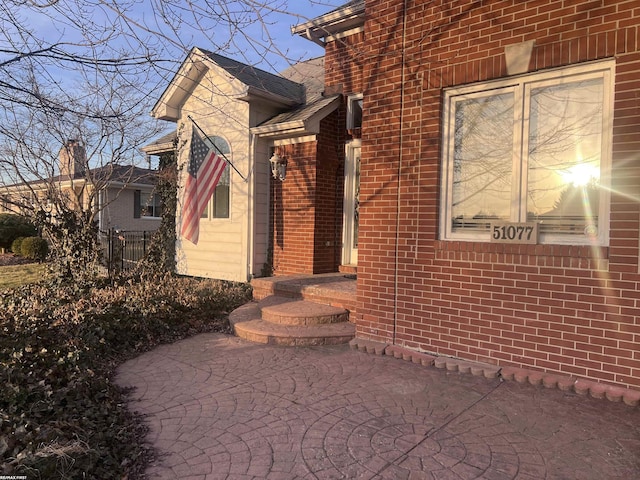 exterior space with brick siding and fence