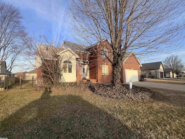 view of front of property featuring brick siding, fence, a front yard, a garage, and driveway