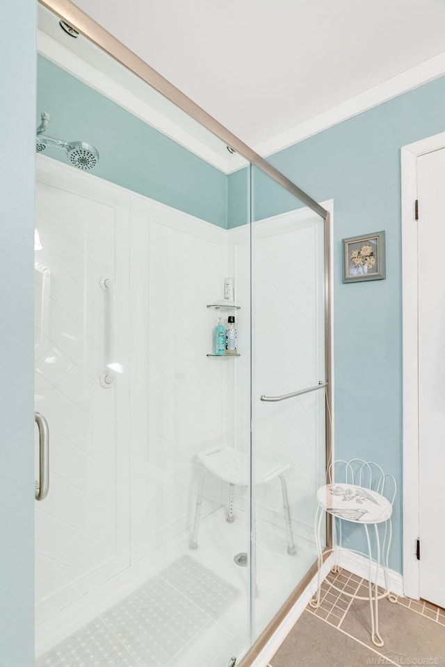 full bath featuring baseboards and a shower stall