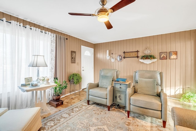 sitting room with plenty of natural light and a ceiling fan