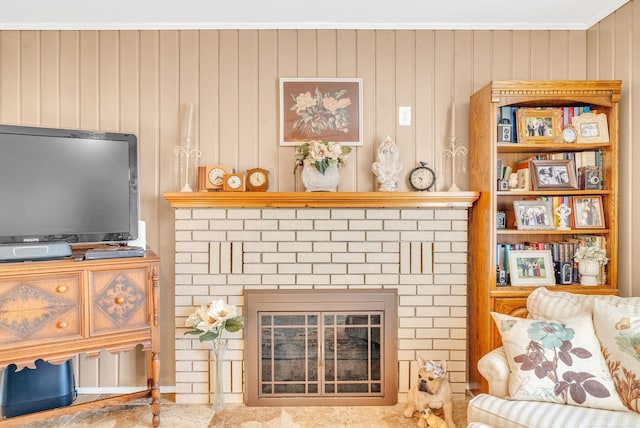 living room with a fireplace and ornamental molding