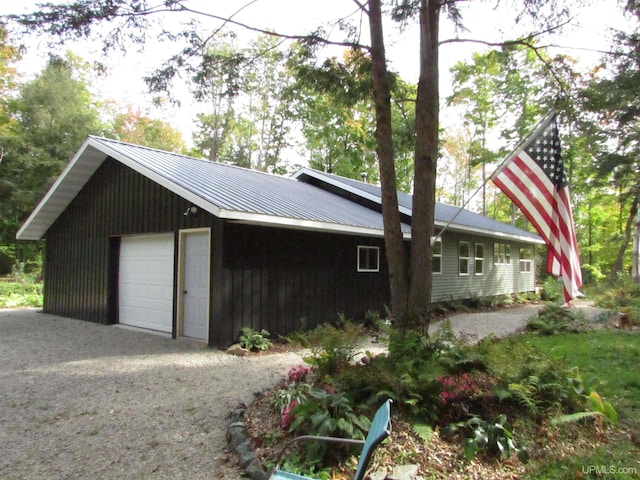 detached garage featuring gravel driveway