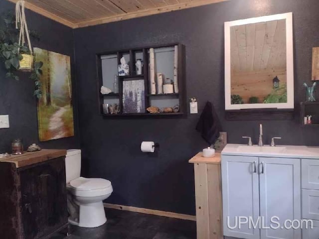 bathroom with wooden ceiling, toilet, vanity, and baseboards