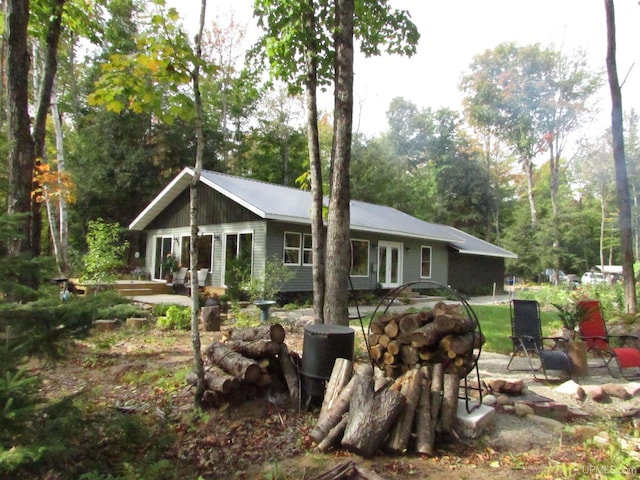 back of property featuring a patio area, french doors, and metal roof