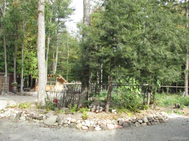 view of yard featuring fence and a view of trees