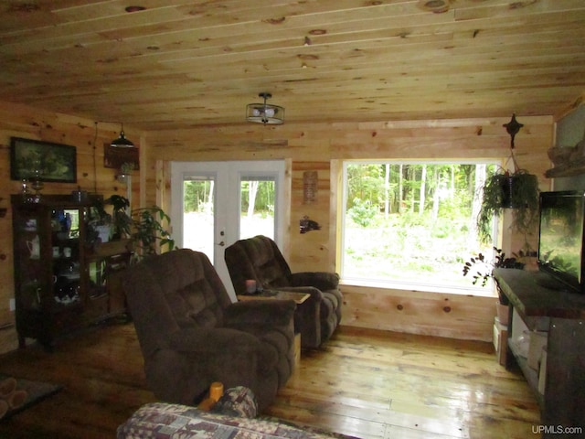 living room with a wealth of natural light, french doors, wooden ceiling, and light wood-style floors