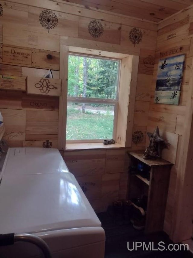 laundry room featuring laundry area and wood walls