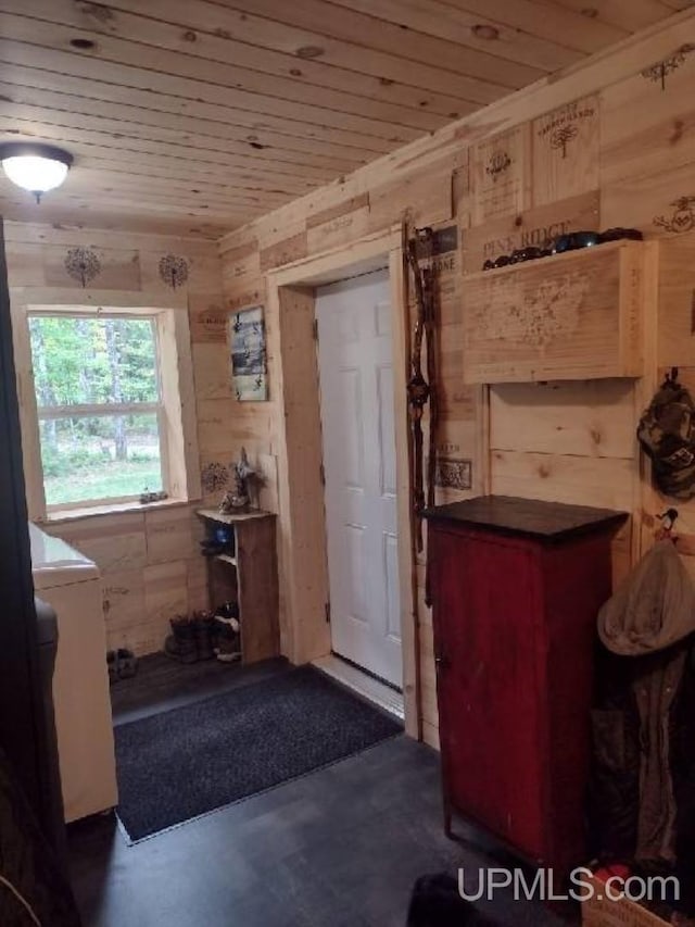 bathroom featuring concrete floors, wood walls, and wooden ceiling