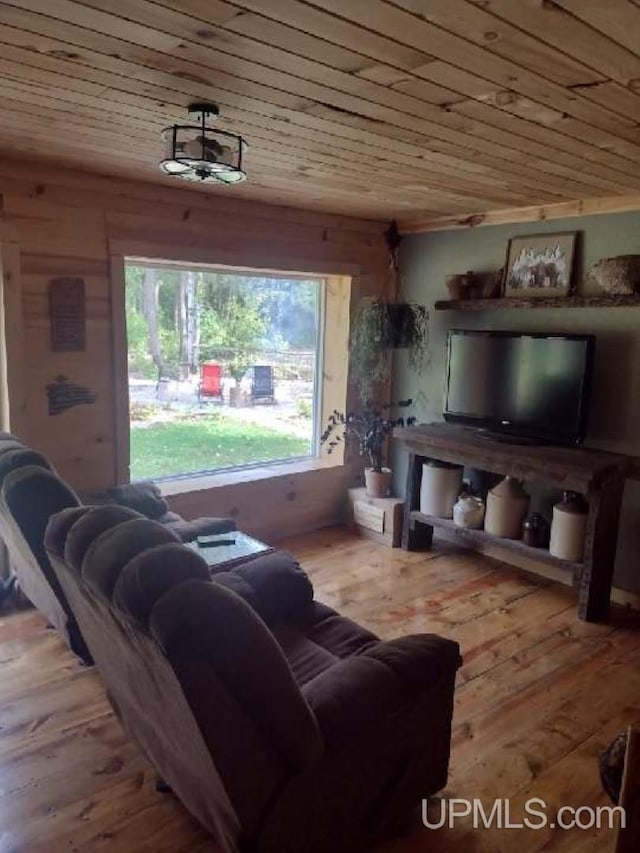 living area with wooden ceiling and wood finished floors