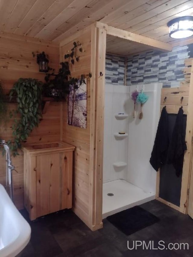 full bath featuring wooden ceiling, a stall shower, and wood walls