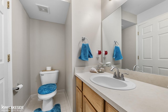 bathroom with tile patterned floors, visible vents, toilet, baseboards, and vanity