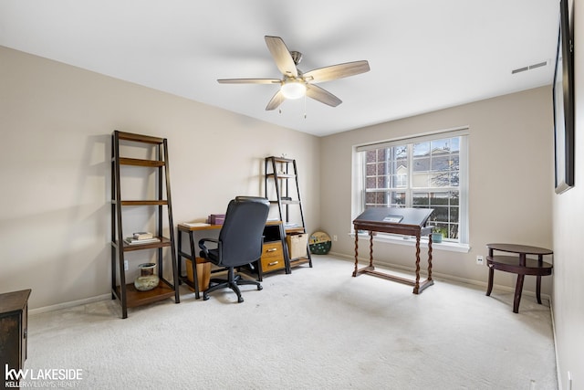 carpeted office space with visible vents, a ceiling fan, and baseboards