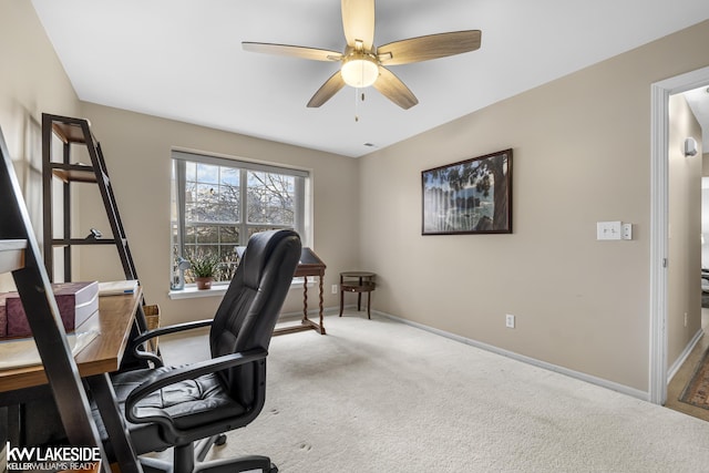 office space with baseboards, a ceiling fan, and carpet floors