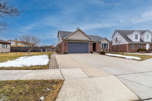 view of front of home with driveway, fence, an attached garage, brick siding, and a chimney