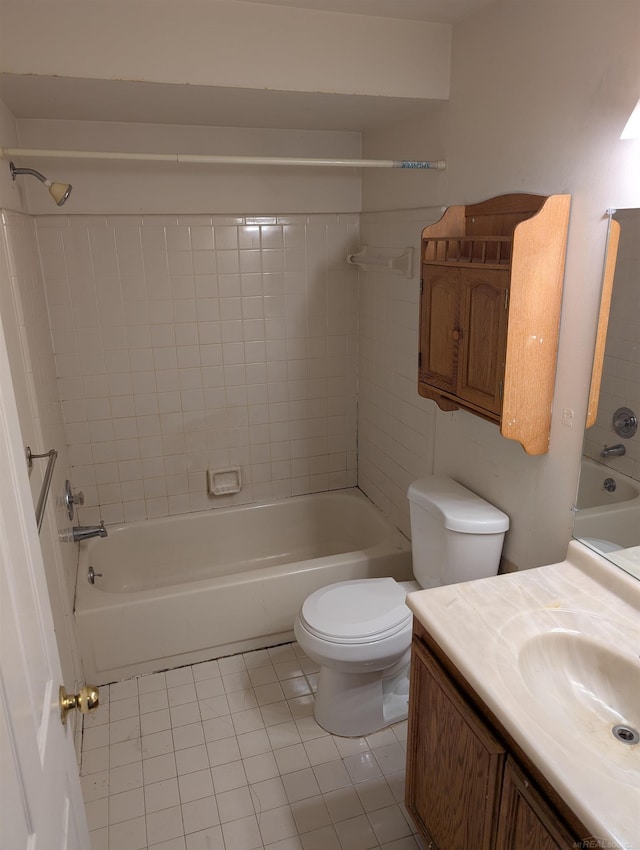 bathroom with vanity, toilet,  shower combination, and tile patterned flooring