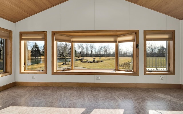 unfurnished sunroom featuring lofted ceiling, wood ceiling, and a healthy amount of sunlight