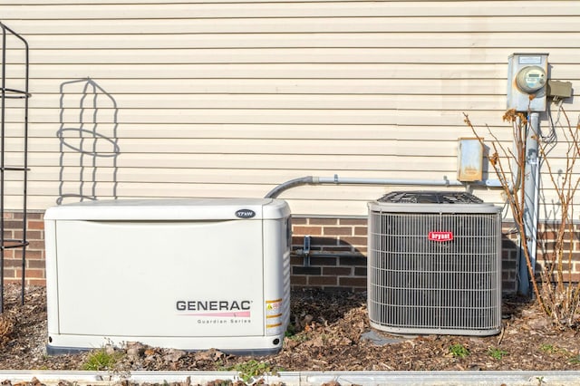 exterior details with electric meter, a power unit, and central AC