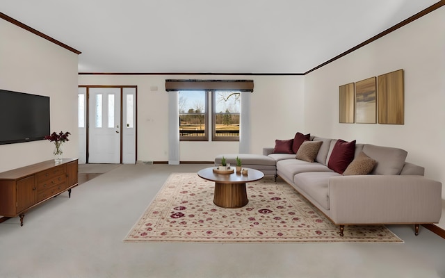 carpeted living area with crown molding, plenty of natural light, and baseboards