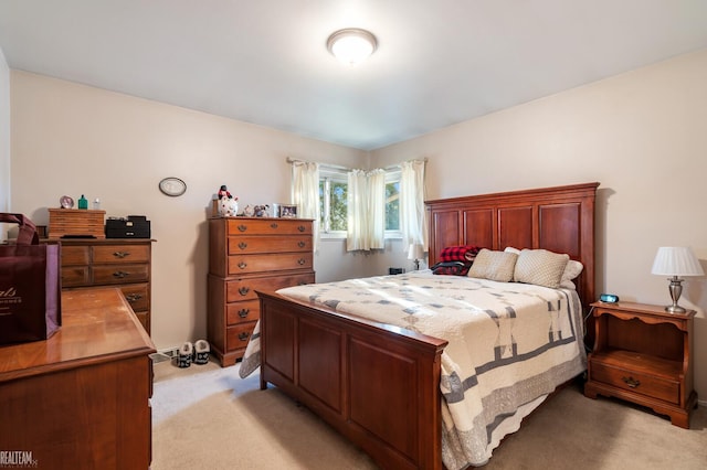 bedroom featuring light colored carpet