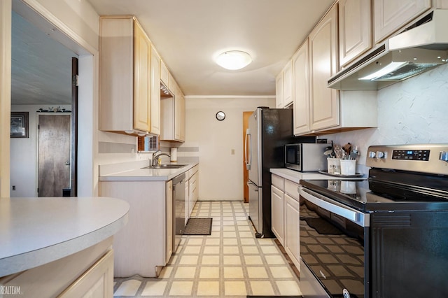 kitchen featuring under cabinet range hood, light floors, light countertops, appliances with stainless steel finishes, and a sink