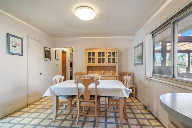 dining space featuring visible vents and light floors