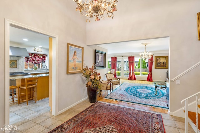 foyer featuring tile patterned flooring, french doors, baseboards, and an inviting chandelier