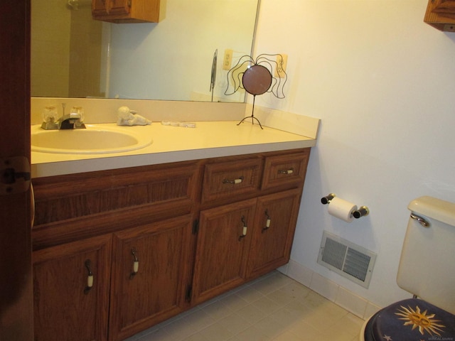 bathroom with visible vents, toilet, and vanity