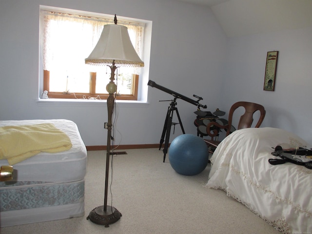 carpeted bedroom featuring baseboards and vaulted ceiling