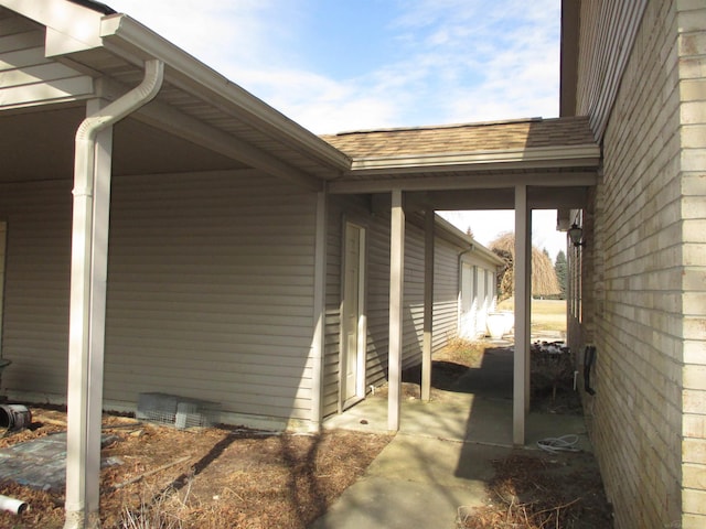 exterior space with crawl space and roof with shingles