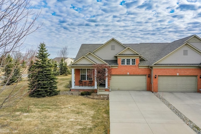 traditional home with a front yard, brick siding, a porch, and driveway