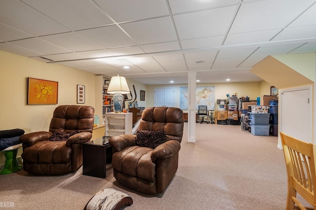 living area with a paneled ceiling and carpet floors