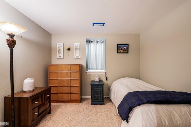 bedroom with light colored carpet