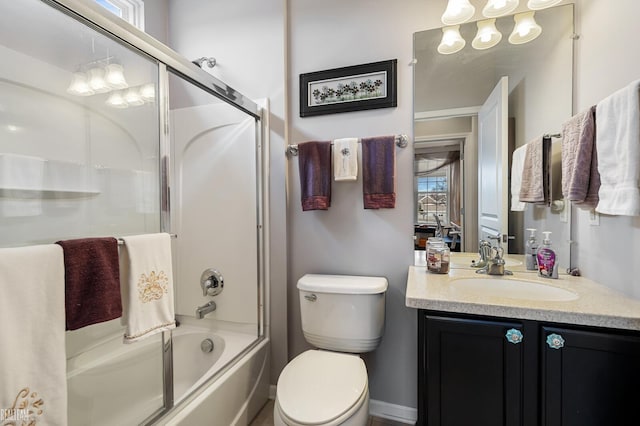 bathroom featuring shower / bath combination with glass door, vanity, and toilet