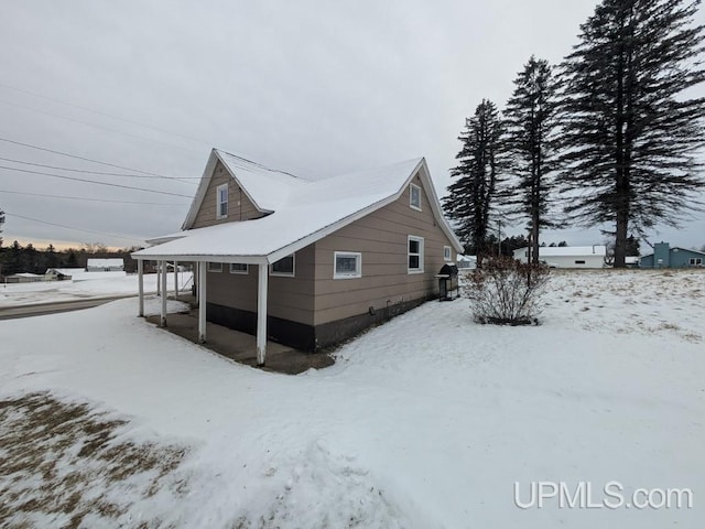 snow covered property featuring a garage