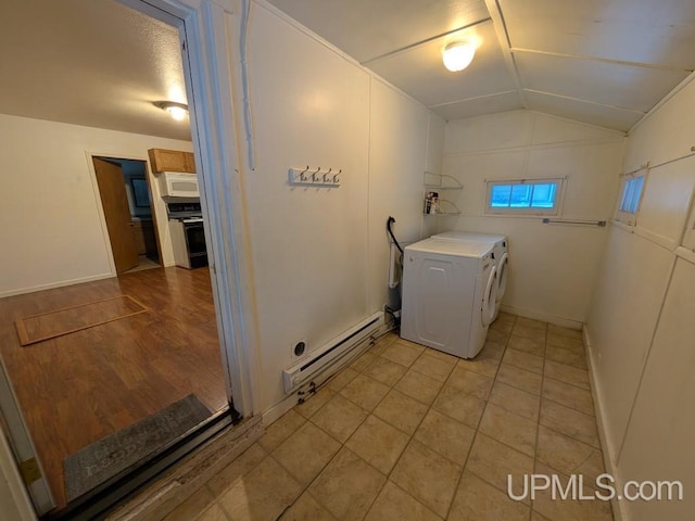 washroom with light tile patterned floors, laundry area, washer / clothes dryer, and a baseboard heating unit