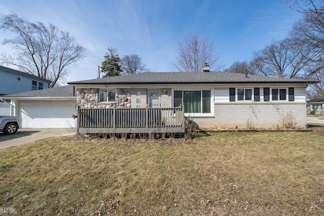 ranch-style home with brick siding, an attached garage, concrete driveway, and a front lawn