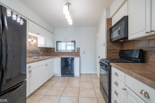 kitchen with light tile patterned floors, backsplash, black appliances, and a sink