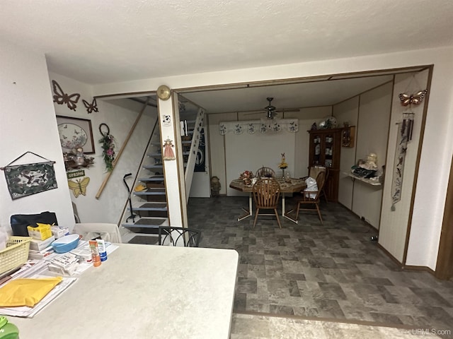 dining area featuring stairway and stone finish flooring