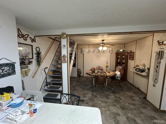 dining space featuring stairs and ceiling fan