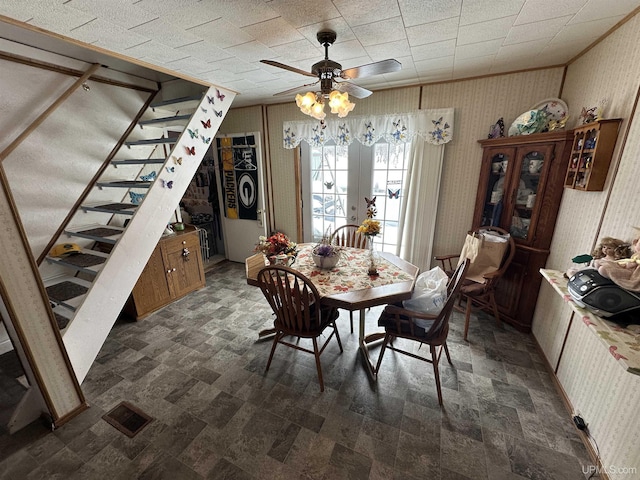 dining room with visible vents, a ceiling fan, french doors, stairway, and wallpapered walls