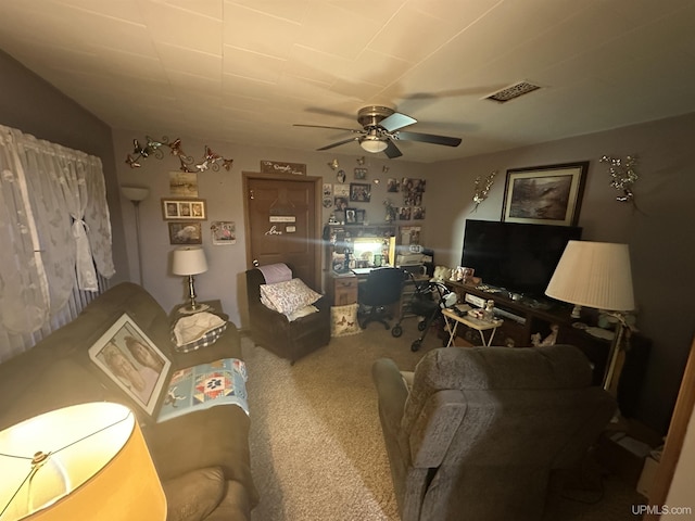 living area featuring carpet flooring, ceiling fan, and visible vents