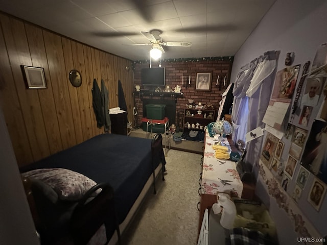 carpeted bedroom with wood walls and a ceiling fan