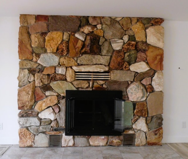 interior details featuring a stone fireplace and visible vents