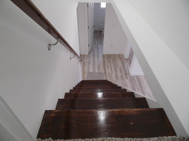 stairway featuring wood finished floors