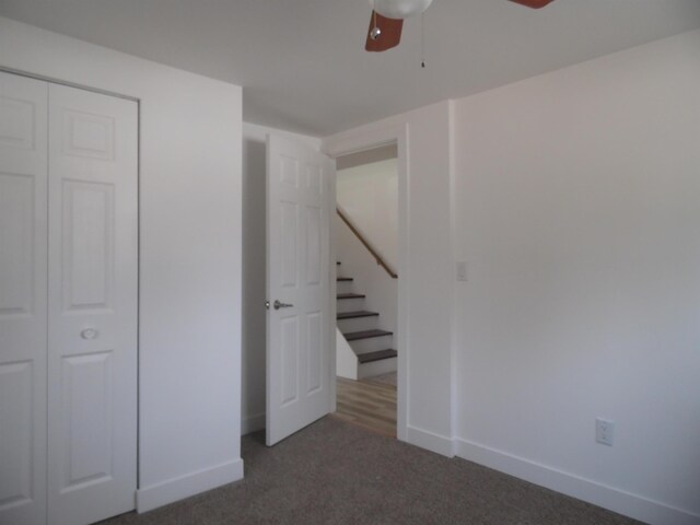 basement with carpet flooring, ceiling fan, and baseboards