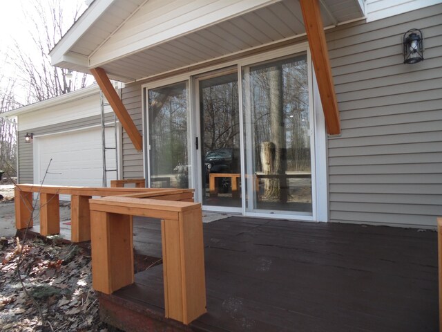 view of patio with a wooden deck and a garage